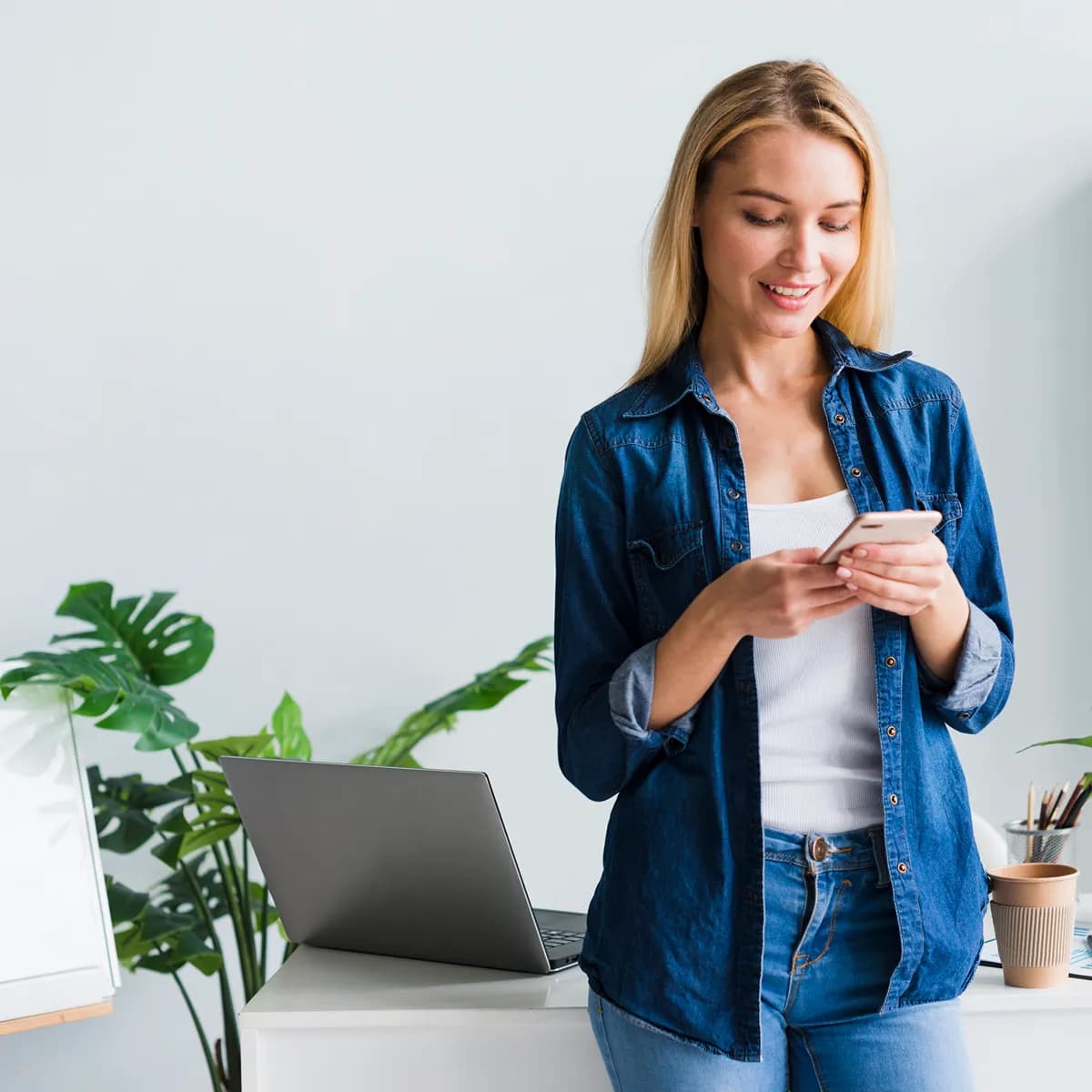 beautiful-young-female-using-smartphone-office